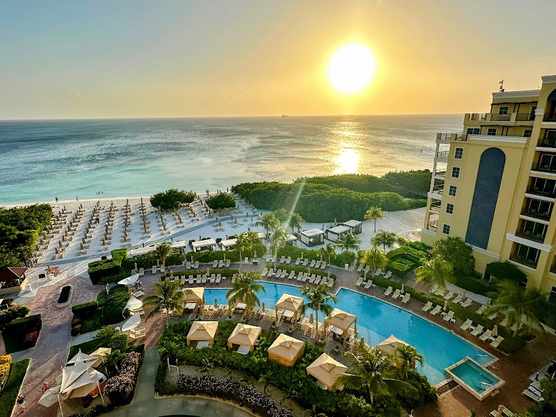 Sunset over the pool, gardens, and Palm Beach at The Ritz-Carlton, Aruba